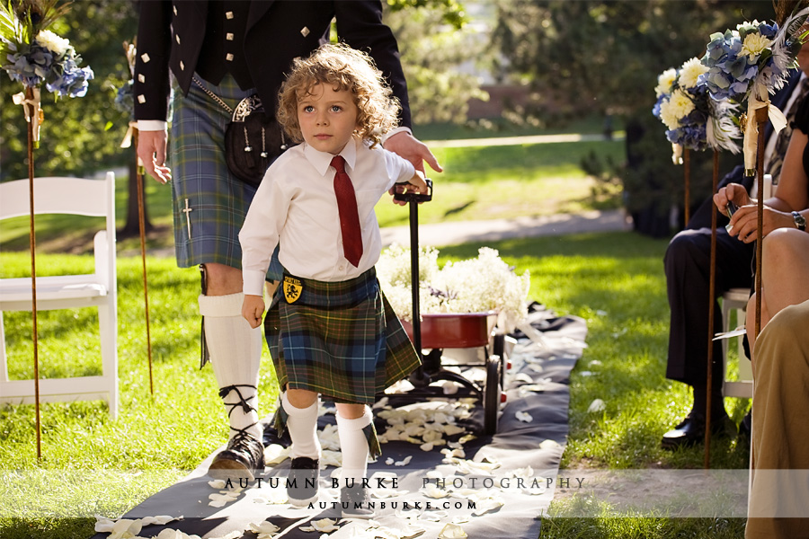 colorado wedding ceremony ring bearer in kilt pulling wagon