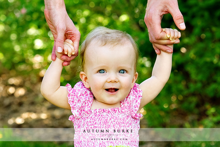 denver colorado cute baby holding parents' hands