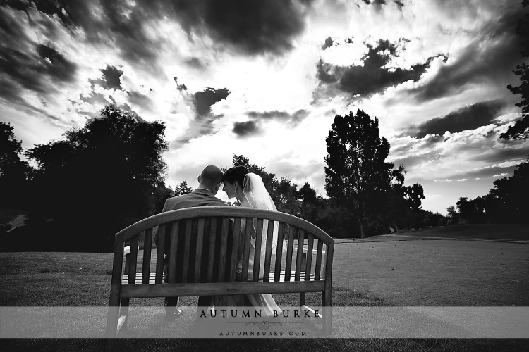 denver country club colorado wedding bride and groom on bench dramatic sky