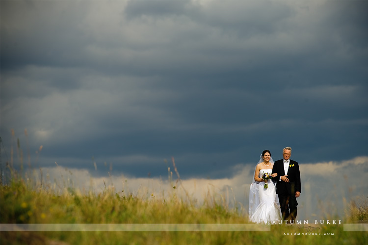 vail wedding deck ceremony father walking bride down the aisle dramatic sky