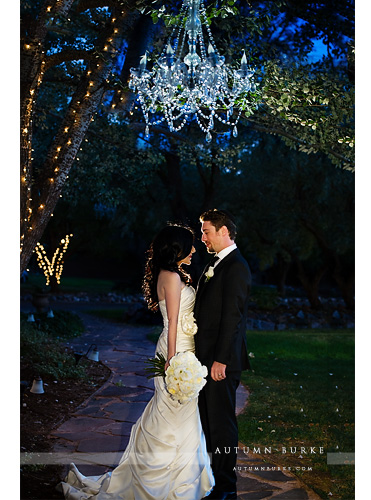 colorado wedding bride and groom under chandelier outdoors at night lionsgate