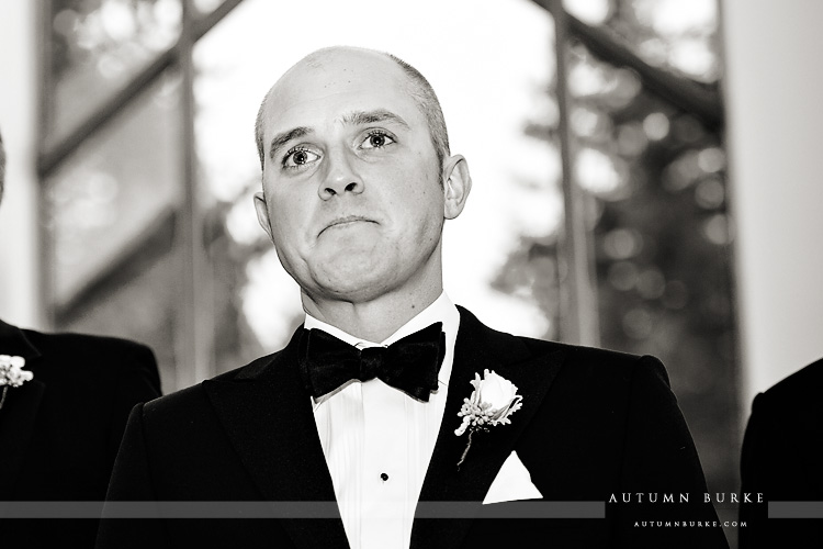 vail chapel winter wedding ceremony groom sees bride walking down aisle colorado