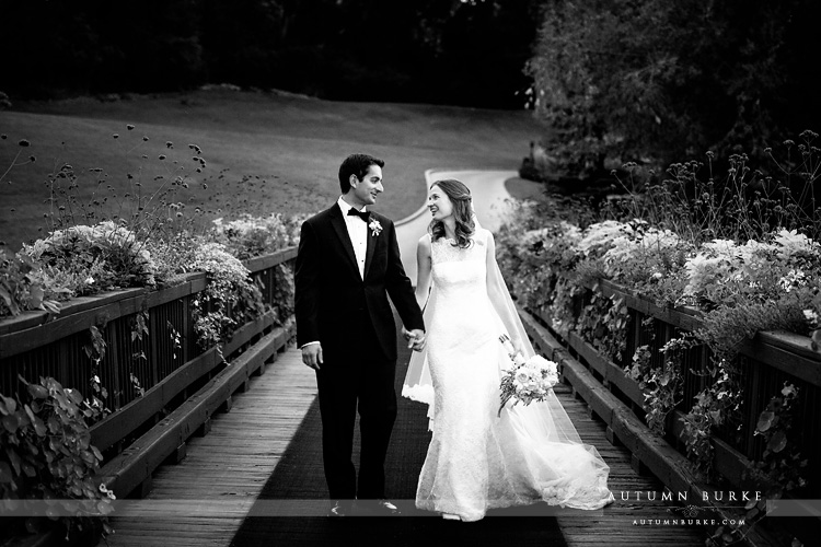 bride and groom walking on bridge at denver country club wedding colorado