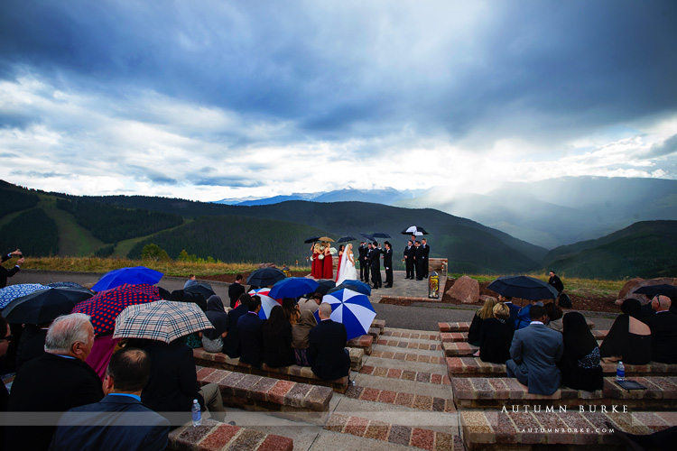 vail wedding deck rainy ceremony bride and groom umbrellas