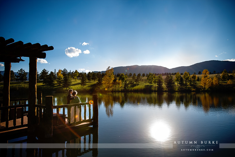 spruce mountain ranch wedding bride and groom by lake with mountains colorado