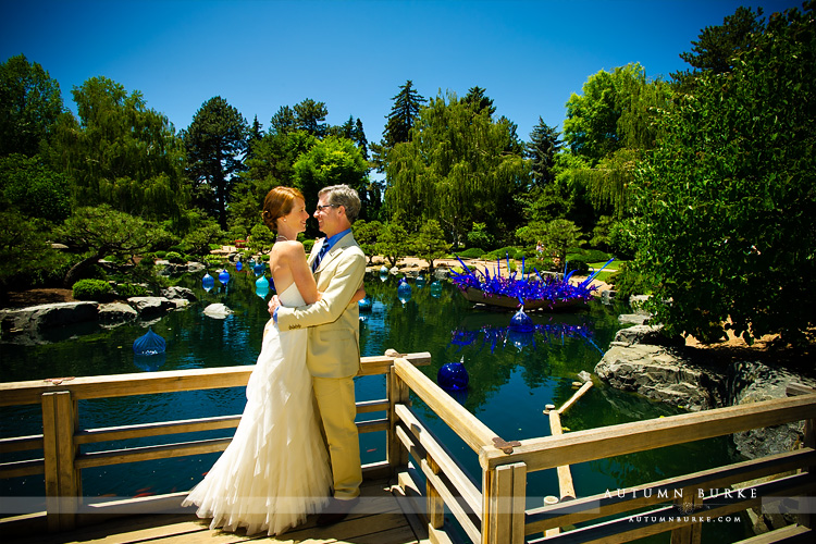bride and groom and chihuly glass sculpture denver botanic gardens wedding colorado