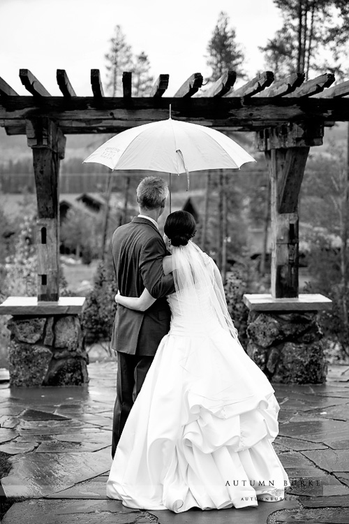 bride and groom with umbrella devils thumb ranch wedding ceremony