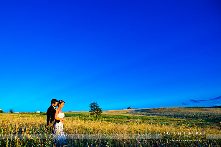 highlands ranch mansion wedding reception bride and groom field sunset