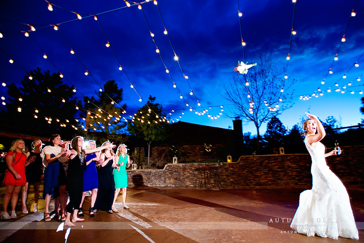 spruce mountain ranch bouquet toss wedding reception bride market lights