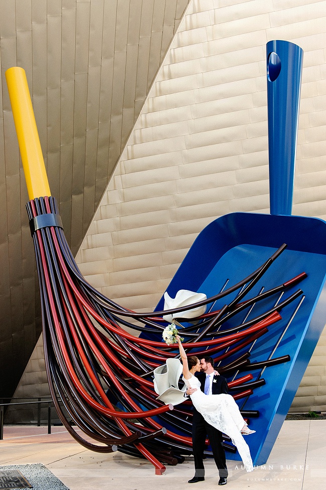 downtown denver art museum wedding bride and groom just married broom sculpture sweep me off my feet