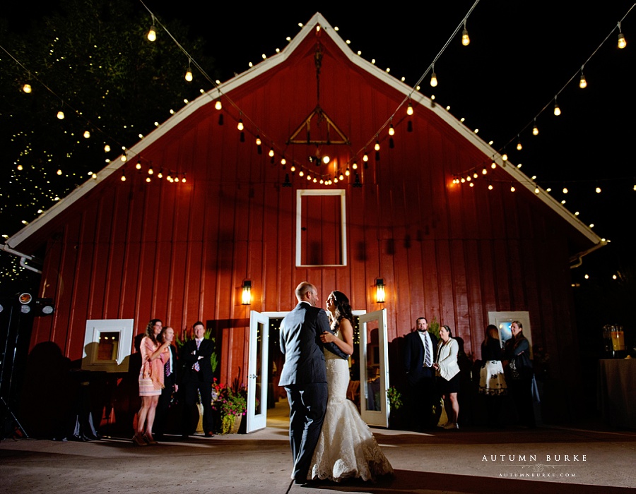 chatfield botanic gardens barn wedding first dance outdoors night market lights bride and groom