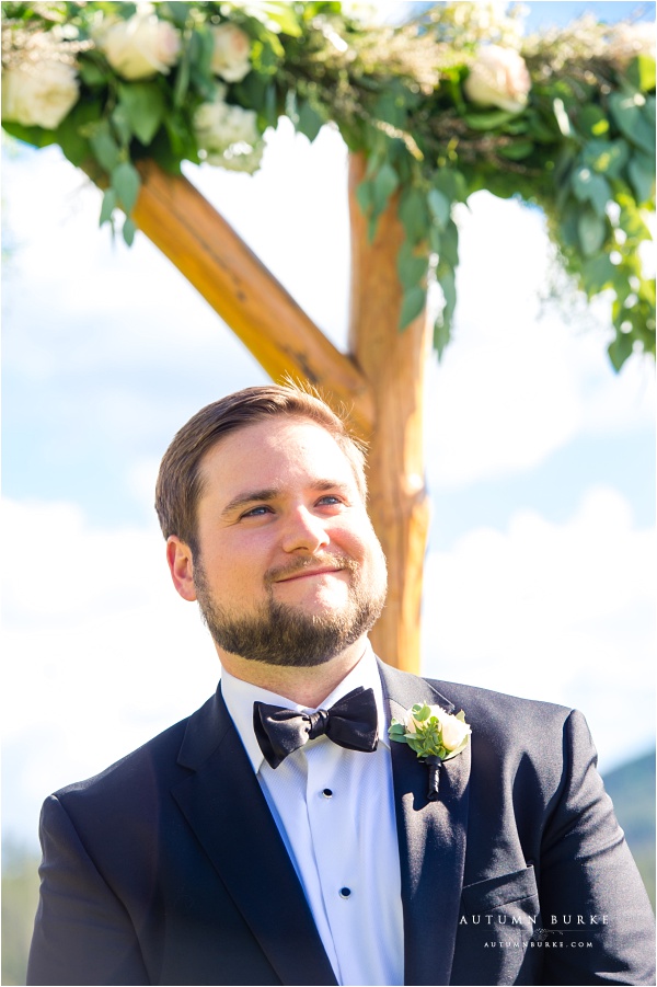 colorado mountain wedding ceremony groom sees bride