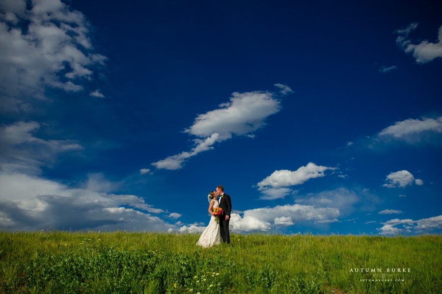 vail colorado mountain wedding vail wedding deck bluebird sky bride and groom portrait